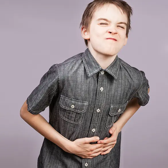 Child holding his abdomen having stomachache